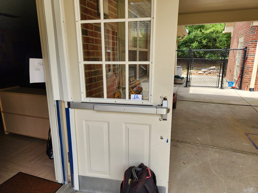 Commercial lock and exit device installed on a wood door in Raleigh
